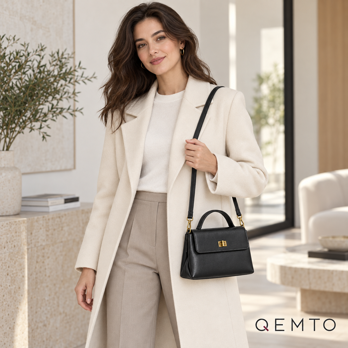 QEMTO Vera Top-Handle Bag in black leather worn by a model with top handle