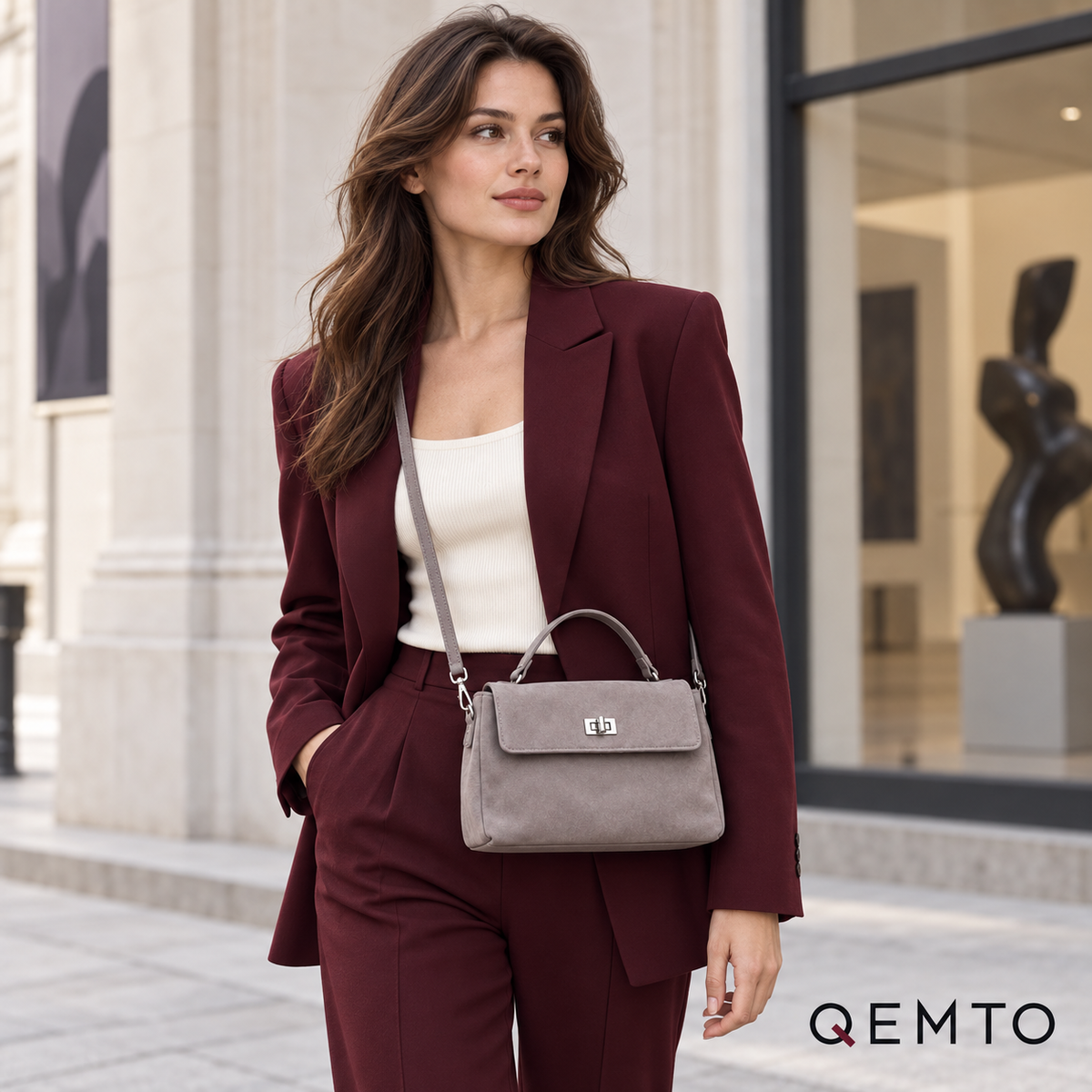 QEMTO Vera Top-Handle Bag in grey suede worn by a model with top handle